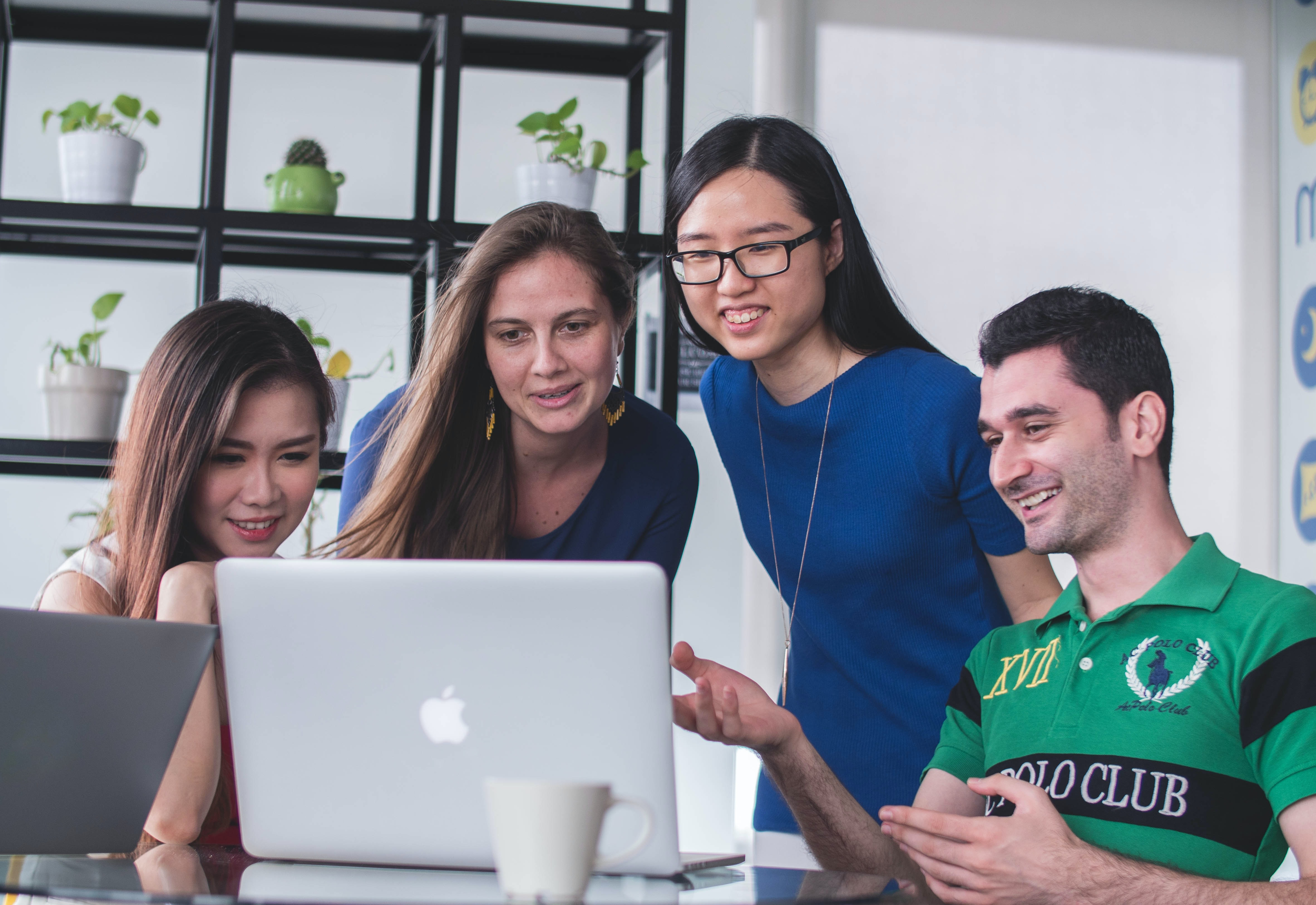 group of people around a laptop